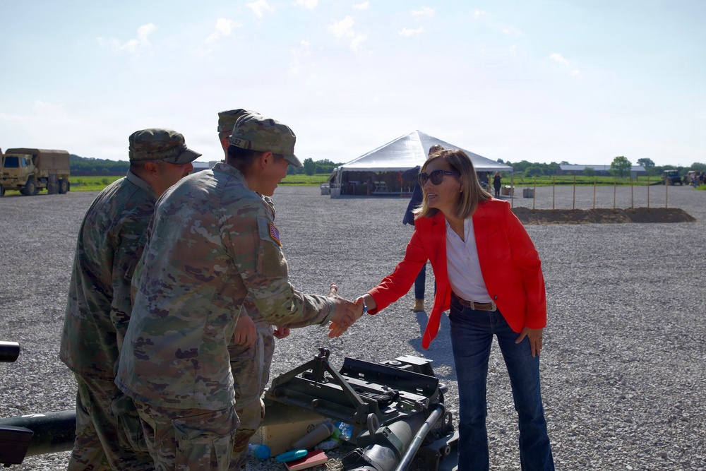 Government officials shake the hands of U.S. Soldiers as they set up for the groundbreaking ceremony for the future artillery complex at the Iowa Army Ammunition Plant.