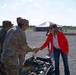 Government officials shake the hands of U.S. Soldiers as they set up for the groundbreaking ceremony for the future artillery complex at the Iowa Army Ammunition Plant.
