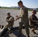 Soldiers remove cartridge cases from the artillery rounds being fired to celebrate the groundbreaking ceremony for the future artillery complex at the Iowa Army Ammunition Plant.