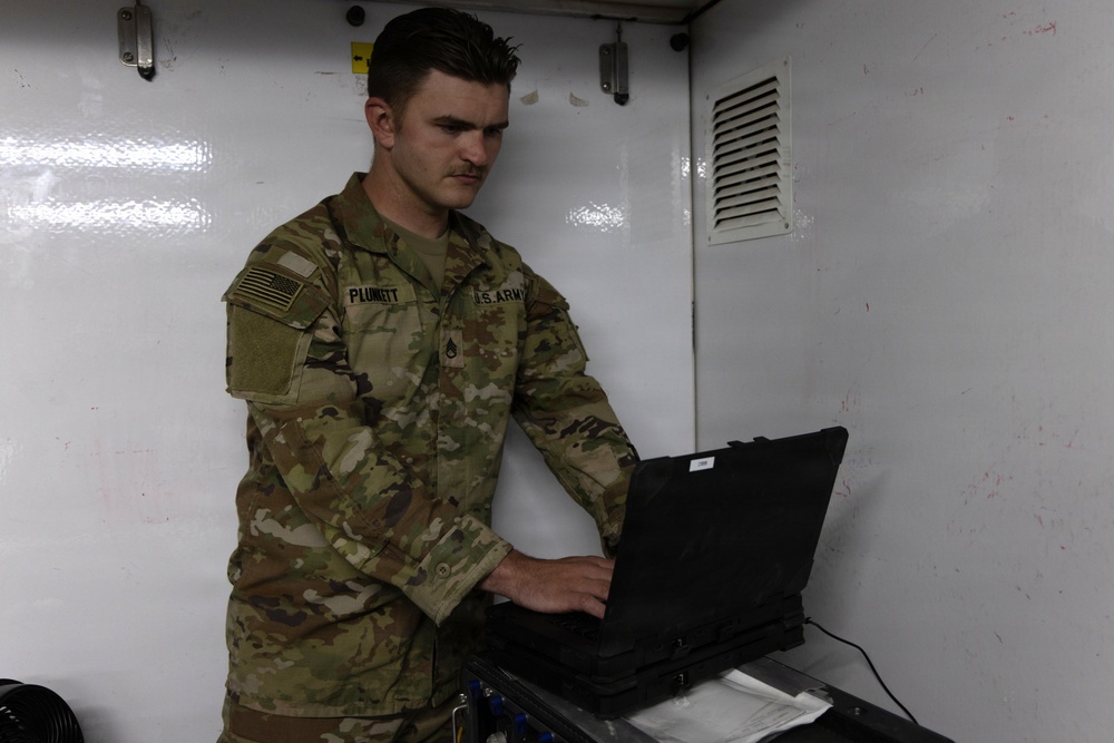 US Soldier uses tactical communications and video-teleconferencing capability