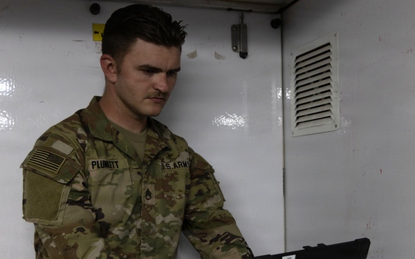 US Soldier uses tactical communications and video-teleconferencing capability
