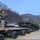 Heavy equipment transporter loads armored recovery vehicle