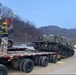 Heavy equipment transporter loads armored recovery vehicle