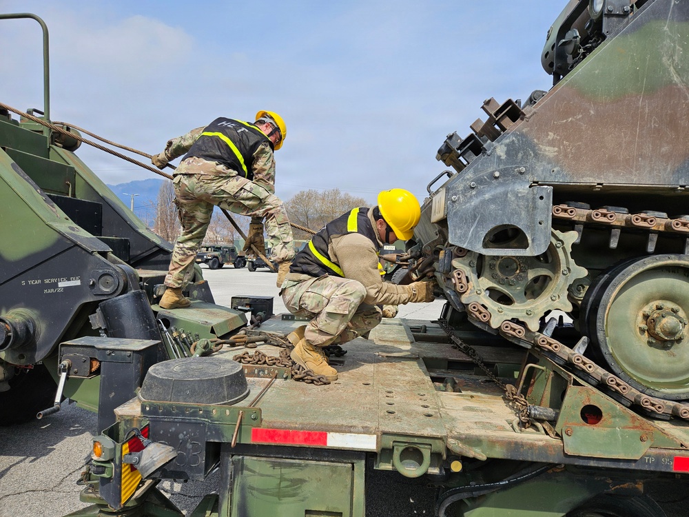 Soldiers secure armored vehicle during winch training