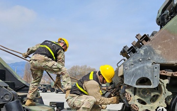 Soldiers secure armored vehicle during winch training