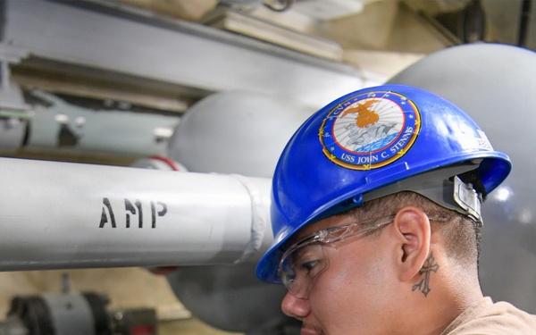 USS John C. Stennis (CVN 74) Sailor conducts maintenence