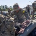 U.S. Army soldiers are conducting a gear inspection or layout drill in an outdoor area, likely on a military installation. Multiple soldiers in OCP (Operational Camouflage Pattern) uniforms are sorting through and organizing large amounts of military equipment spread across the ground. The scene appears to be a formal equipment accountability or pre-deployment inspection.