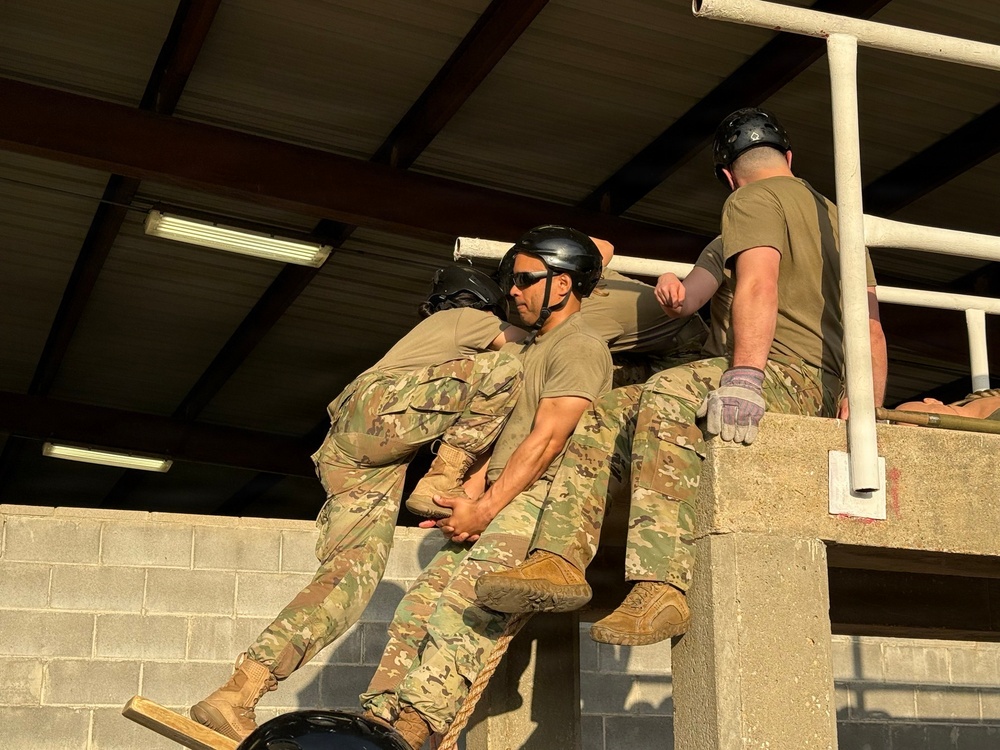 Squadron Officer School students completing obstacle in Leadership Reaction Course