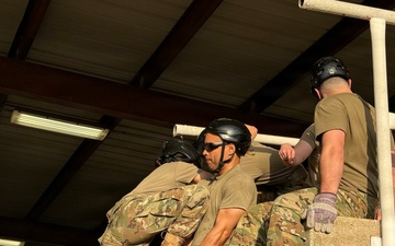 Squadron Officer School students completing obstacle in Leadership Reaction Course