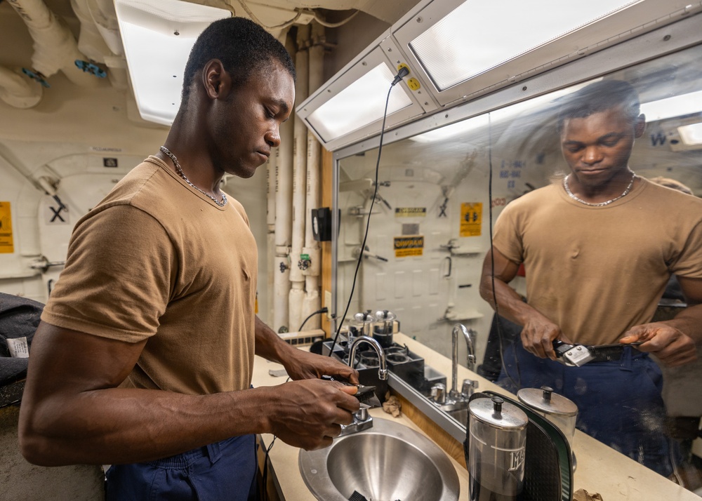 USS Ross Sailor Prepares Barbershop for Haircuts