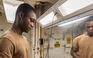 USS Ross Sailor Prepares Barbershop for Haircuts
