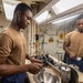 USS Ross Sailor Prepares Barbershop for Haircuts
