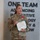 USARIEM COC/Relinquishment of Responsibility 2026 A U.S. Army Colonel named Rosser, wearing Army Combat Uniform (ACU) in MultiCam pattern, stands holding an official certificate while displaying a medal pinned to her chest. She appears to be speaking during a military award ceremony. The background features a large sign reading 'ONE TEAM ADVANCING INNOVATIVE TECHNOLOGY & TOMORROW'.