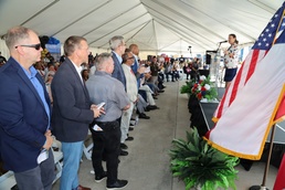 Dignitaries Stand During Remarks at Military or Civic Ceremony Held Under Large Event Tent