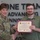 USARIEM COC/Relinquishment of Responsibility 2026 A U.S. Army soldier in camouflage uniform is presenting a certificate to a young civilian man named Dylan D. Marconi. The certificate is from 'The United States Army B.R.A.T.' program, recognizing individuals for 'Being Born Rough and Tough.' The ceremony is taking place in front of a wall displaying the motto 'ONE TEAM ADVANCING INNOVATION.'