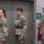 USARIEM COC/Relinquishment of Responsibility 2026 Three U.S. Army soldiers in Operational Camouflage Pattern (OCP) uniforms are standing at attention or parade rest in what appears to be an indoor facility. Two females are on the left and center, and one male is on the right. They appear to be participating in a formal military ceremony or official event.