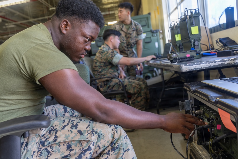 MWCS-18 Marines set up communication equipment