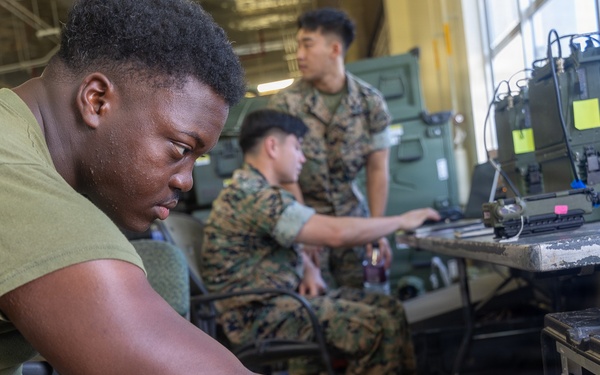 MWCS-18 Marines set up communication equipment