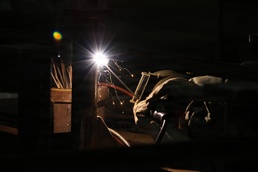 U.S. Naval Ship Repair Facility and Japan Regional Maintenance Center (SRF-JRMC) Master Labor Agreement employee conducts welding operations