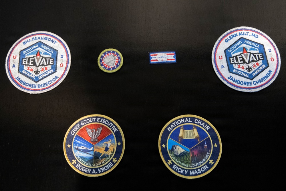 The image shows a collection of six Scouting America patches displayed on a dark surface, all related to the 2026 National Scout Jamboree with the theme 'ELEVATE'. The patches represent high-ranking leadership positions including Jamboree Director, Jamboree Chairman, Chief Scout Executive, and National Chair. Each patch is personalized with the name of the individual holding that position.
