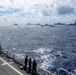U.S. Coast Guardsmen observe multinational ships sail in formation during RIMPAC 2026