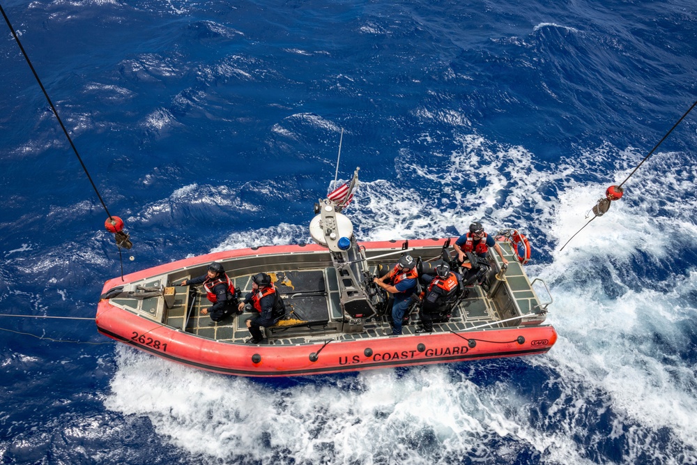 U.S. Coast Guard over-the-horizon small boat prepares to be hoisted off the coast of O'ahu