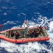 U.S. Coast Guard over-the-horizon small boat prepares to be hoisted off the coast of O'ahu