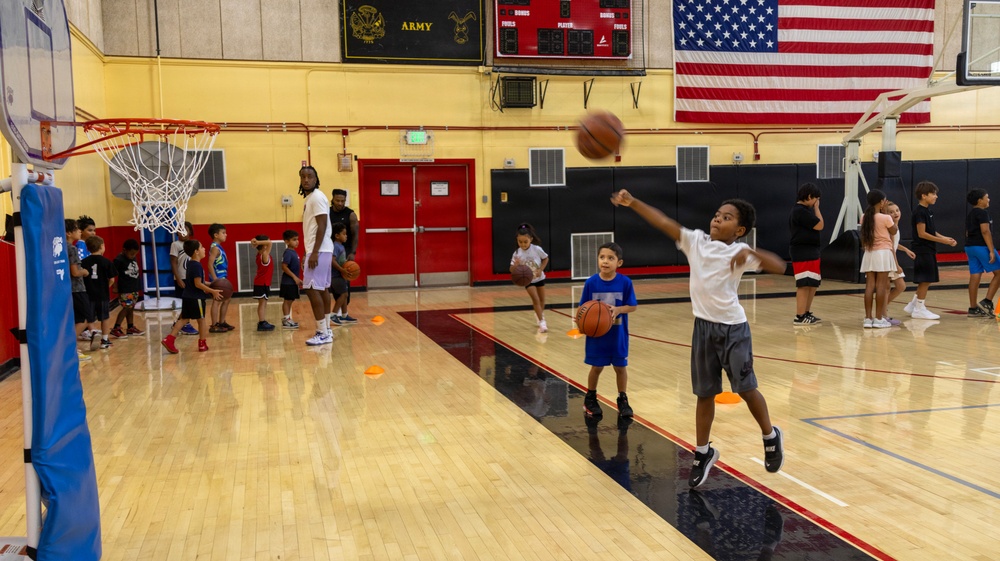 Youth basketball camp led by Christain Taylor, a professional international basketball player, at the Semper Fit base gym aboard Marine Corps Logistics Base Barstow, California, August 1.