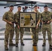 Four military personnel in British Army Multi-Terrain Pattern (MTP) camouflage uniforms pose together in front of a helicopter at what appears to be a military airbase hangar. Two of the individuals are holding a framed award display that reads 'First Place' and appears to be from a competition called 'LEAPFEST 2019', featuring gold medals and military insignia. The group appears to be celebrating a competitive achievement.