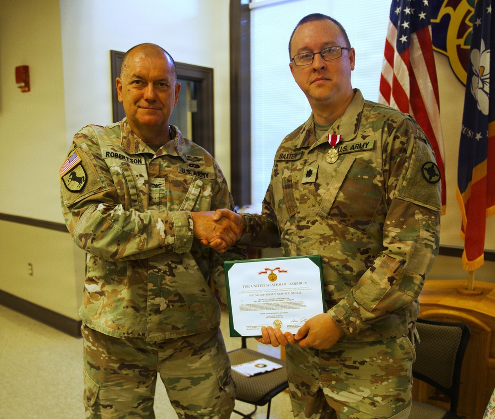 U.S. Army Lt. Col. Charles Baxter, Mississippi Army National Guard, receives the Meritorious Service Medal