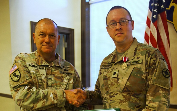 U.S. Army Lt. Col. Charles Baxter, Mississippi Army National Guard, receives the Meritorious Service Medal