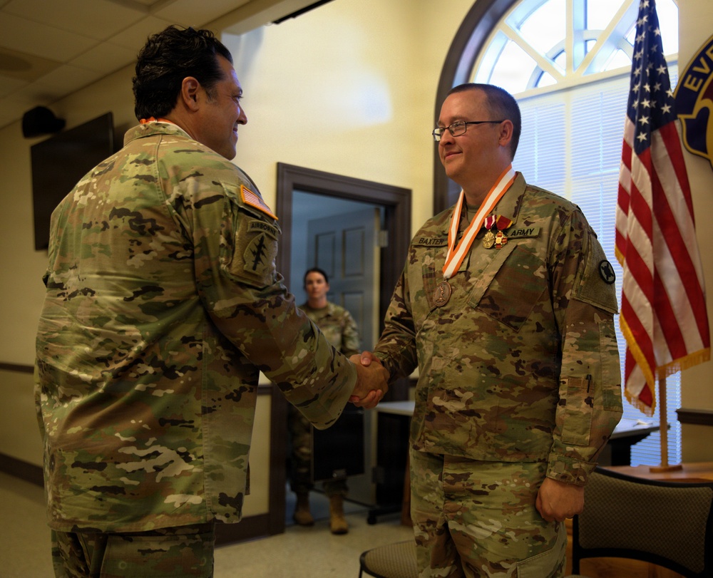 U.S. Army Lt. Col. Charles Baxter, Mississippi National Guard, receives the Bronze Order of Mercury award