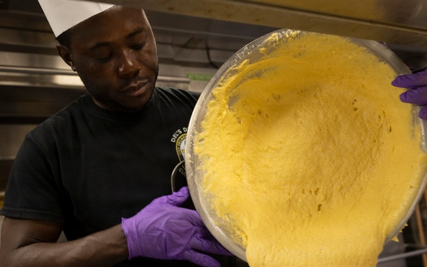 Delbert D. Black Prepares Meal for the Crew