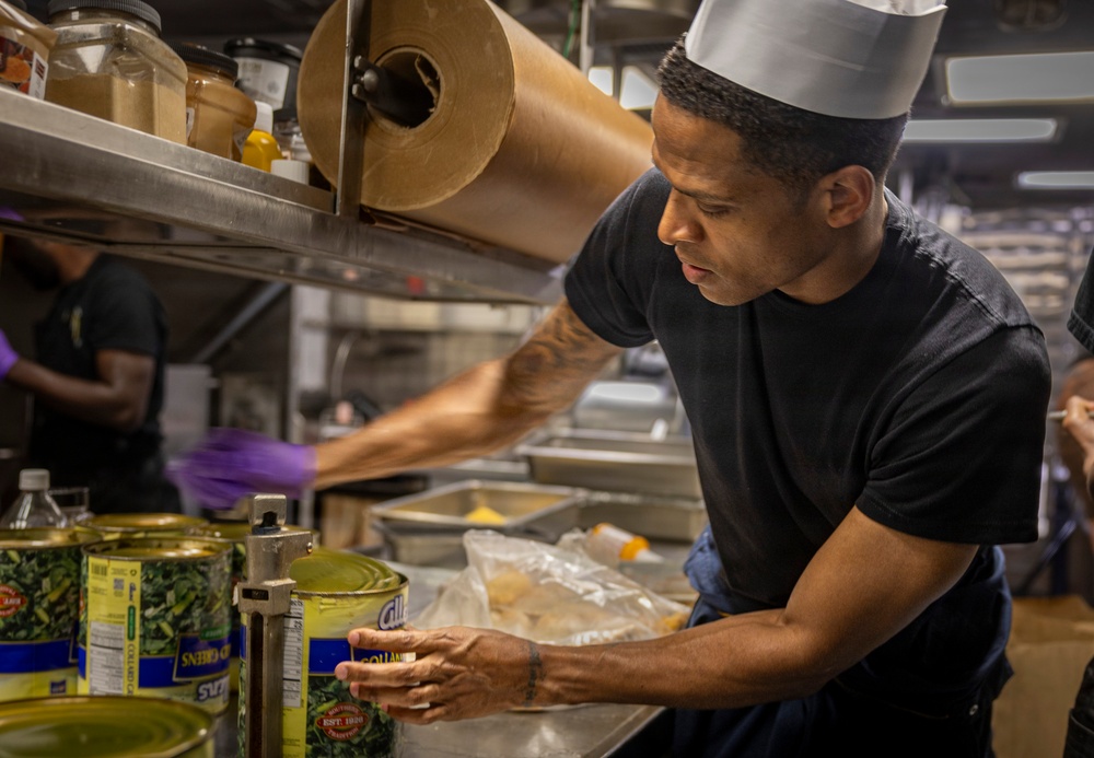 Delbert D. Black Prepares Meal for the Crew