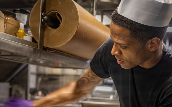 Delbert D. Black Prepares Meal for the Crew