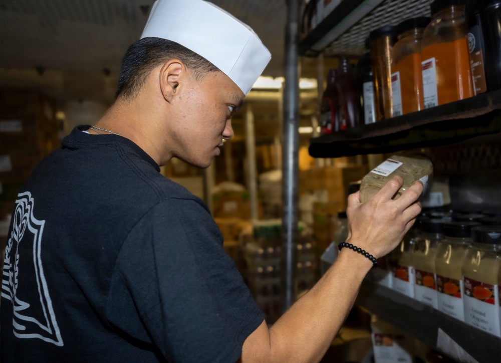 Delbert D. Black Prepares Meal for the Crew