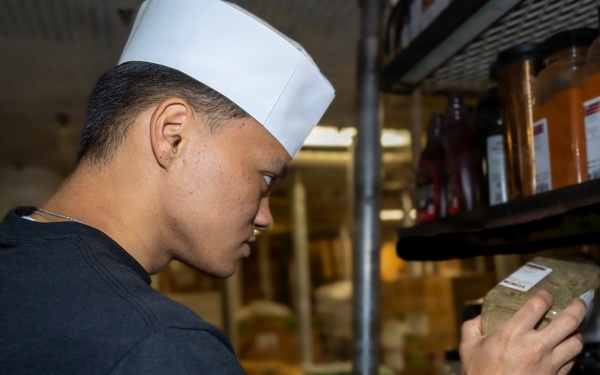 Delbert D. Black Prepares Meal for the Crew
