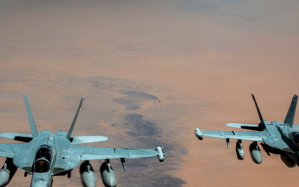 U.S. Air Force KC135 supports U.S. Navy F/A 18 during air refueling