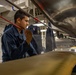 U.S. Navy Sailor Prepares Uniform for Press