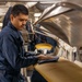 U.S. Navy Sailor Prepares Uniform for Press