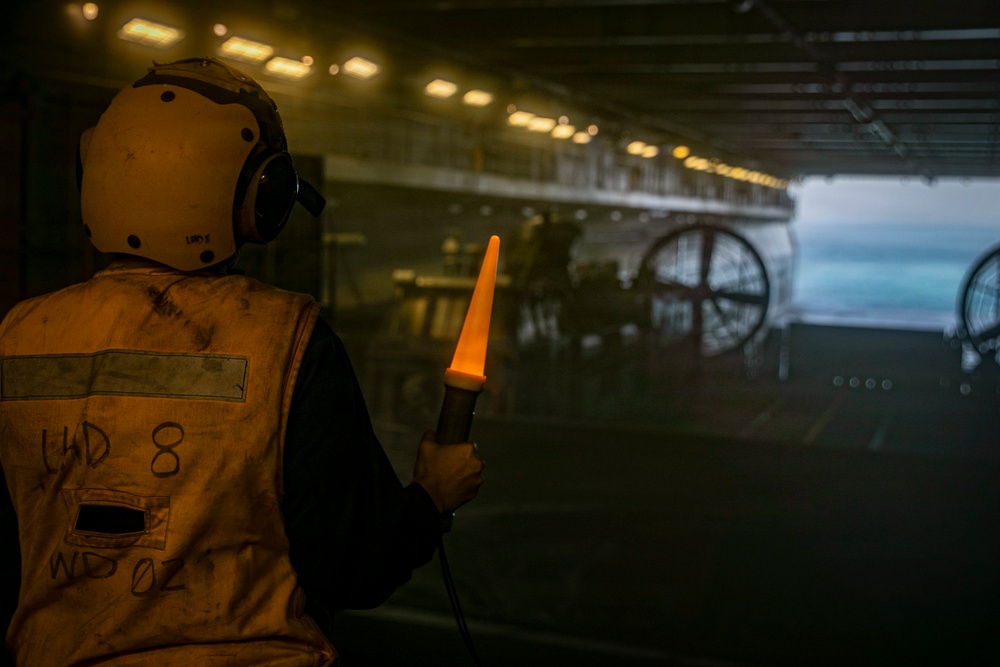 Navy Boatswain's Mate Signals to Landing Craft