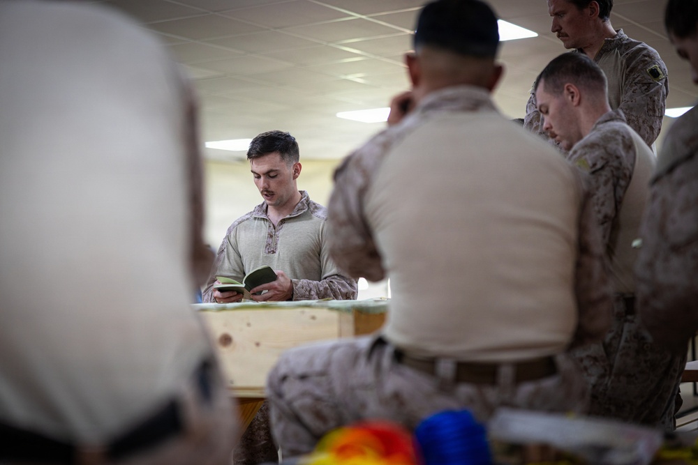 U.S. Marines and Sailors receive an operational order