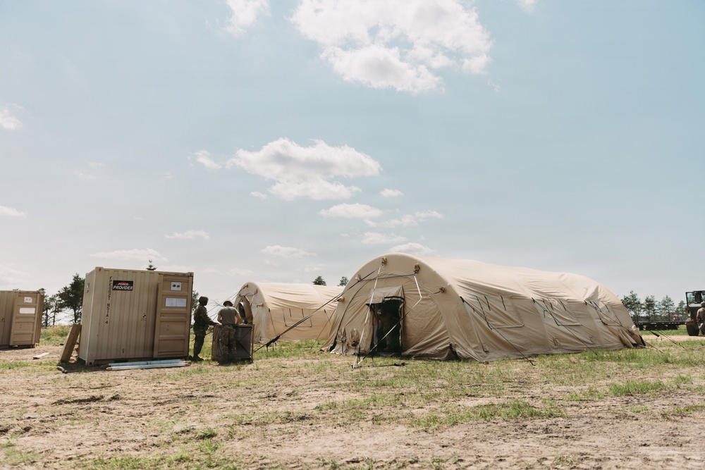 Airmen of the 131st Civil Engineering Squadron and the 139th Civil Engineering Squadron prepare a Forward Opearting Base