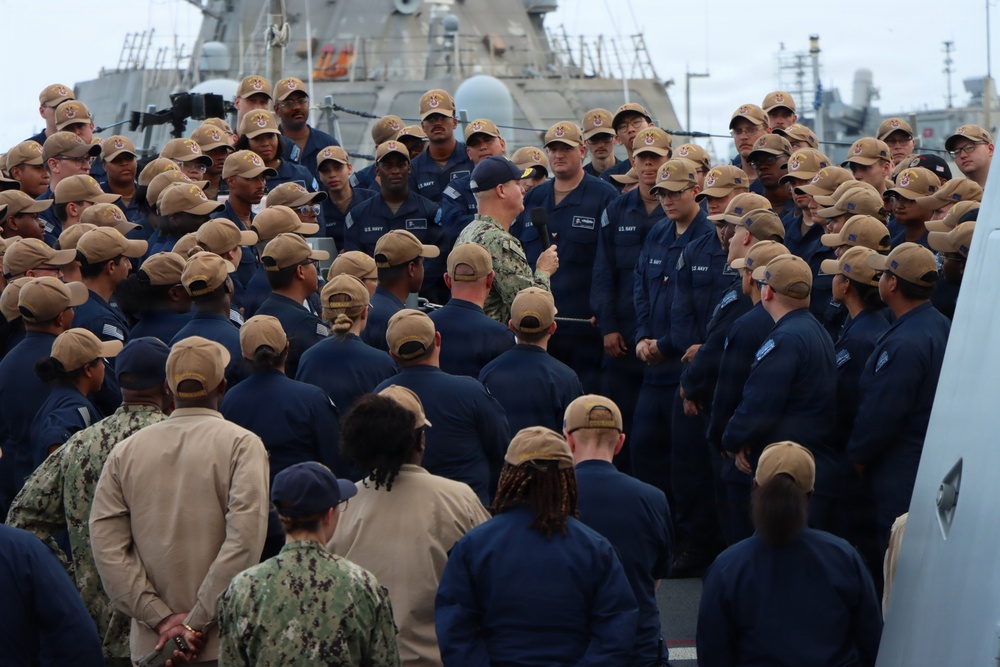 Rear Adm. Christopher Alexander, commander, Naval Surface Force Atlantic (SURFLANT), addresses the crew of USS Ted Stevens (DDG 128).