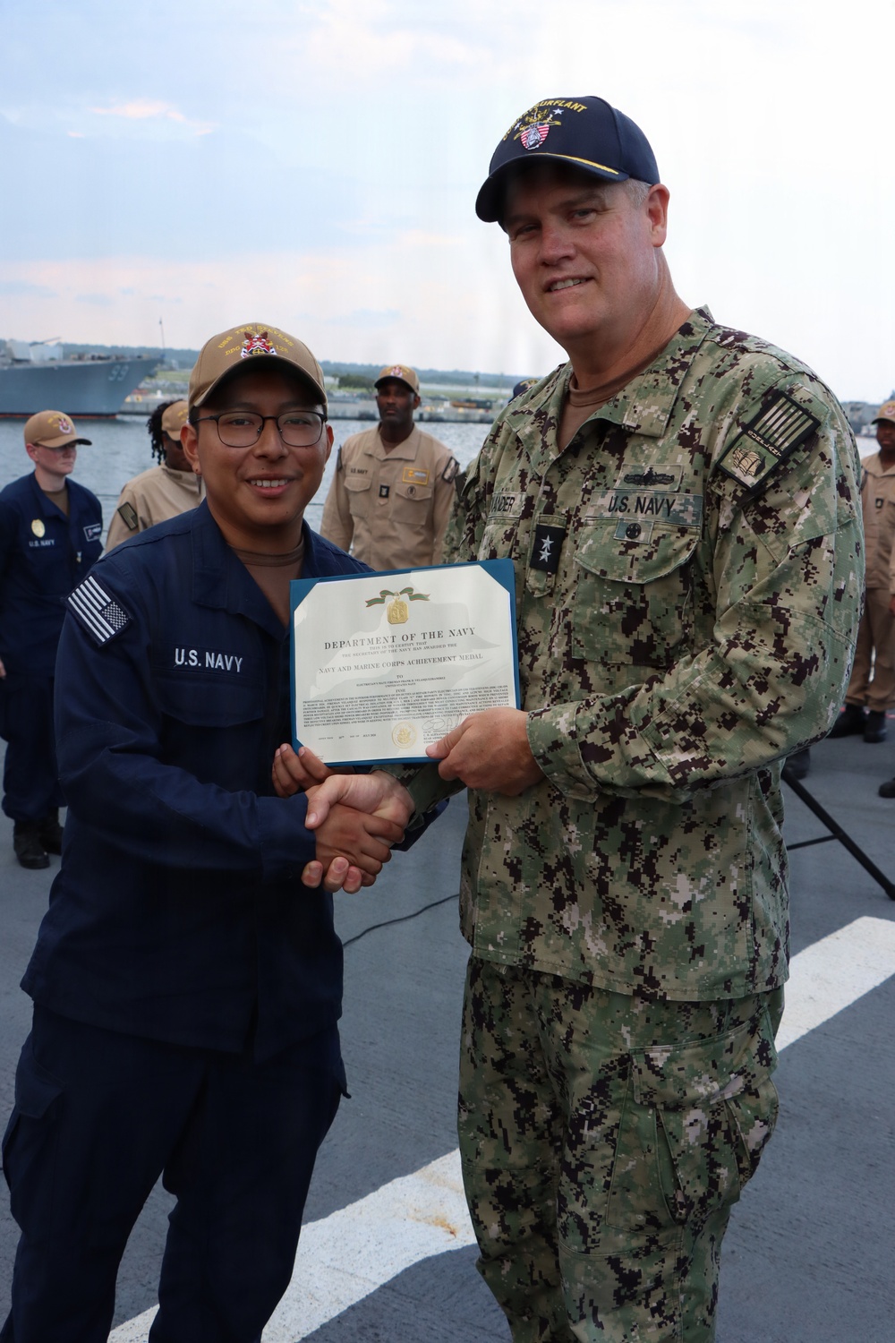 Rear Adm. Christopher Alexander, commander, Naval Surface Force Atlantic (SURFLANT), presents Electrician’s Mate Fireman Frank Velasquez-Ramirez with the Navy and Marine Corps Achievement Medal.