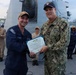 Rear Adm. Christopher Alexander, commander, Naval Surface Force Atlantic (SURFLANT), presents Fire Controlman 1st Class Kevin Hurd with the Navy and Marine Corps Achievement Medal.