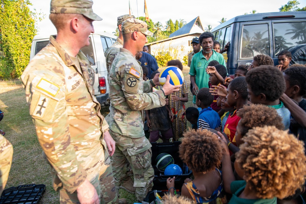 .S. Army Soldiers donate toys, musical instruments, and literature material to the youth of a local village during Tamiok Strike 26