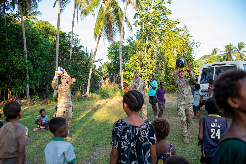 U.S. Army Soldiers donate toys, musical instruments, and literature material to the youth of a local village during Tamiok Strike 26