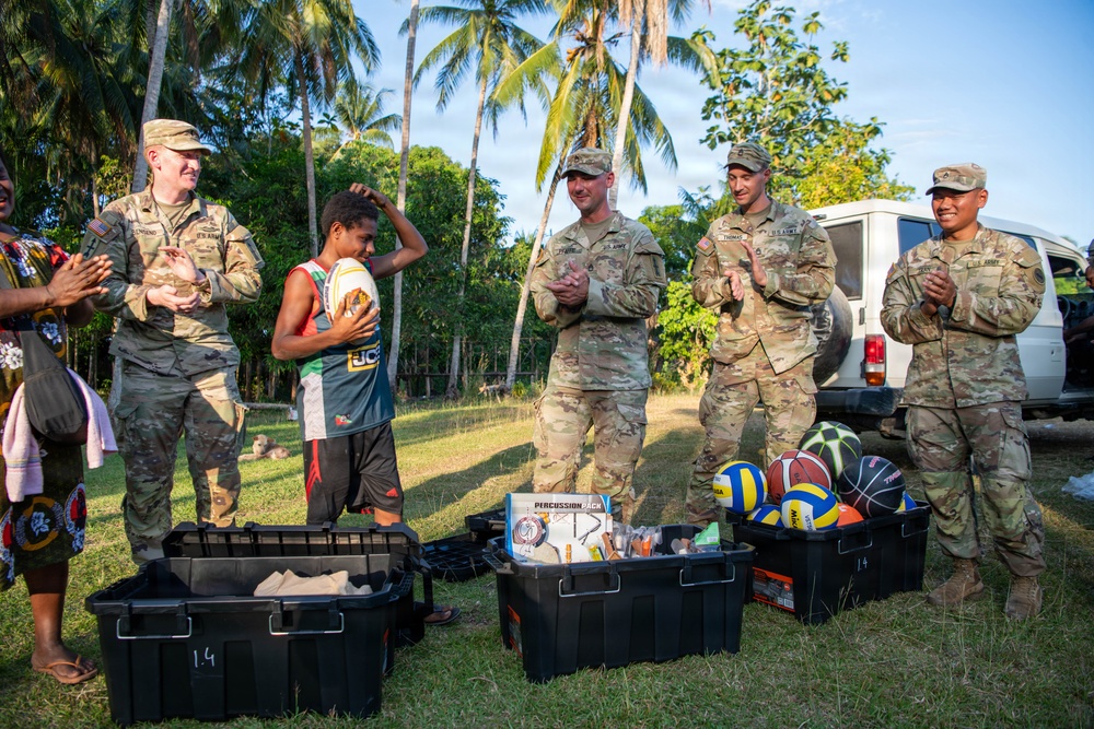 U.S. Army Soldiers donate toys, musical instruments, and literature material to the youth of a local village during Tamiok Strike 26
