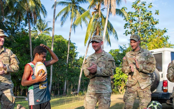 U.S. Army Soldiers donate toys, musical instruments, and literature material to the youth of a local village during Tamiok Strike 26